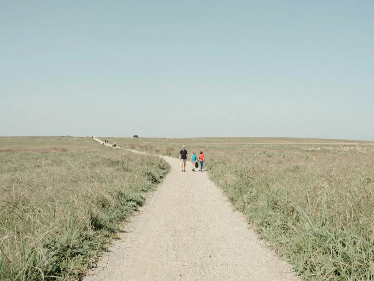 Open meadow with a gentle footpath and a family walking at a dist